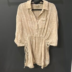 elan size small runs big could fit up to a large cream and khaki color